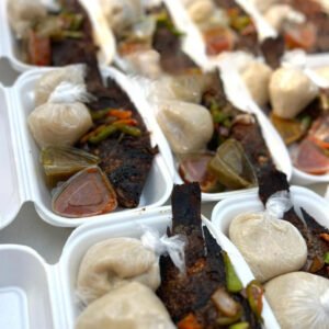 Banku and Spicy Charcoal Grilled Tilapia, 2 balls of banku, 2 types of chilli sauces, chopped veggies